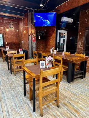 a dining room with wooden tables and chairs at ZEN Hotel Patong Beach -ex- miami Production in Patong Beach