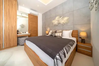 a bedroom with a large bed in a room at Villa private swimming pool and garden in Phuket Town