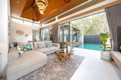 a living room with a couch and a table at Villa private swimming pool and garden in Phuket Town