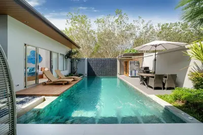 a swimming pool in the backyard of a house at Villa private swimming pool and garden in Phuket Town