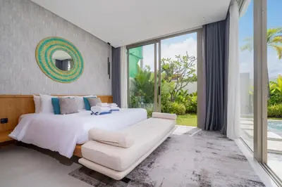 a bedroom with a large white bed and a couch at Luxury villa near Bangtao beach in Phuket Town
