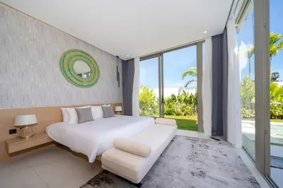 a bedroom with a large bed and a large window at Luxury villa near Bangtao beach in Phuket Town