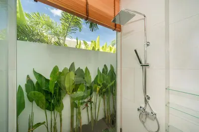 a bathroom with a shower with plants on the wall at Luxury villa near Bangtao beach in Phuket Town