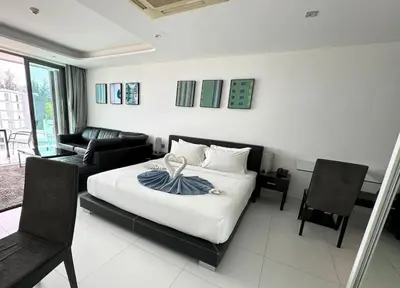 a bedroom with a bed and a living room at Private sea view studio at Twin Sands in Patong Beach