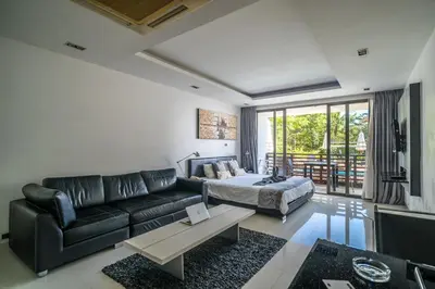 a living room with a couch and a bed at Pool view studio at Nakalay Palm by Lofty in Kamala Beach