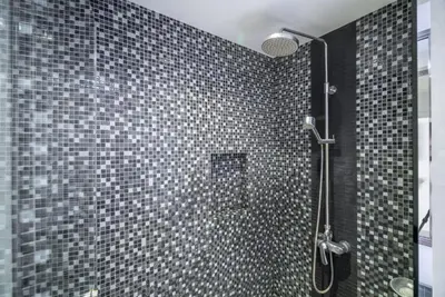 a bathroom with a shower with black and white tiles at Pool view studio at Nakalay Palm by Lofty in Kamala Beach