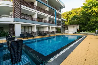 a swimming pool in front of a building at Pool view studio at Nakalay Palm by Lofty in Kamala Beach