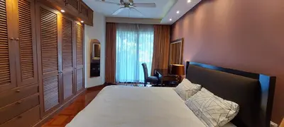 a bedroom with a bed and a desk and a chair at Allamanda Laguna 2 BR c выходом к бассейну in Phuket Town