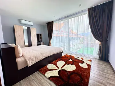 a bedroom with a bed and a large window at The White House Kamala Phuket in Kamala Beach