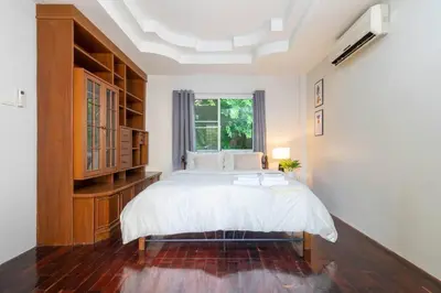 a bedroom with a large bed and a window at Cozy Villa 4 Bedrooms Patong,7mins. walk beach/10mns.Bangla Rd in Patong Beach