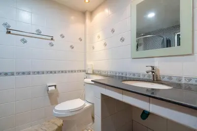 a bathroom with a toilet and a sink and a mirror at Cozy Villa 4 Bedrooms Patong,7mins. walk beach/10mns.Bangla Rd in Patong Beach