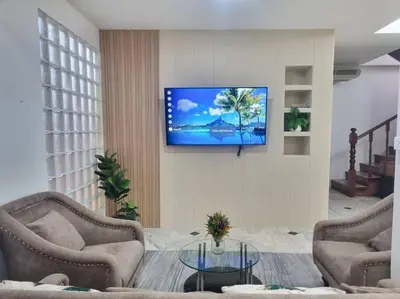 a living room with a flat screen tv on a wall at Cozy Villa 4 Bedrooms Patong,7mins. walk beach/10mns.Bangla Rd in Patong Beach