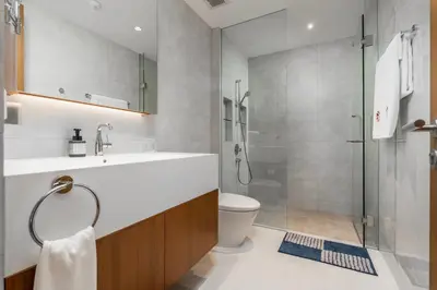 a bathroom with a shower and a sink and a toilet at WEG Elite Beachfront in Phuket Town