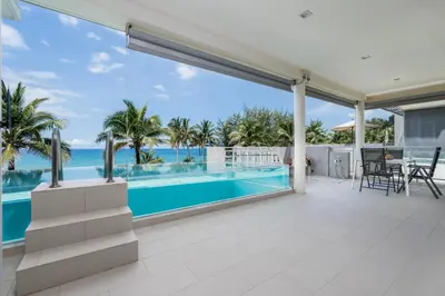 an image of a house with a swimming pool and the ocean at WEG Elite Beachfront in Phuket Town