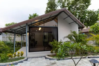 a small house with a glass extension at Rapina House in Mai Khao Beach