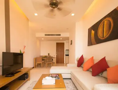 a living room with a white couch and a tv at Krabi Seaview Penthouse in Klong Muang Beach