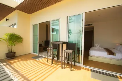 a bedroom with a bed and sliding glass doors at Krabi Seaview Penthouse in Klong Muang Beach