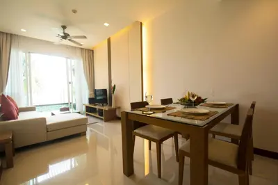 a living room with a table and a couch at Krabi Seaview Penthouse in Klong Muang Beach