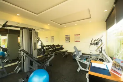 a gym with treadmills and machines in a room at Krabi Seaview Penthouse in Klong Muang Beach