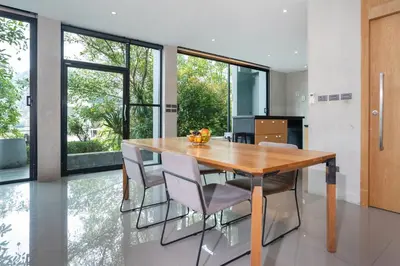 a dining room with a wooden table and chairs at 2BR Pavilion near Kamala Beach, Natural Park P10 in Kamala Beach