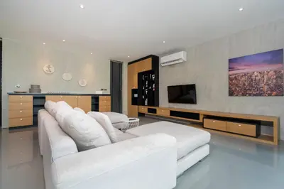 a living room with white furniture and a flat screen tv at 2BR Pavilion near Kamala Beach, Natural Park P10 in Kamala Beach