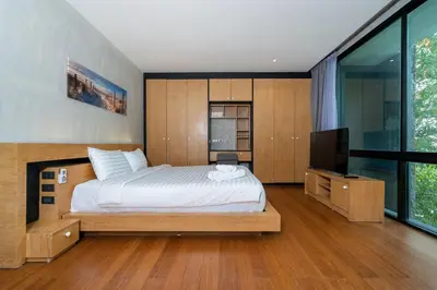 a bedroom with a bed and a flat screen tv at 2BR Pavilion near Kamala Beach, Natural Park P10 in Kamala Beach