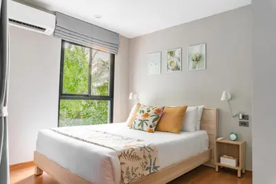 a bedroom with a bed and a window at Title V Lemon Fresh Pool View Gym Hammam in Rawai Beach