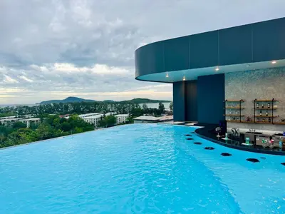 a swimming pool in a building with a view at Duplex in a 5 star hotel La Vita in Phuket Town