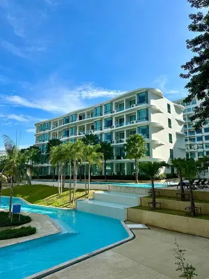 a large building with a pool in front of it at Duplex in a 5 star hotel La Vita in Phuket Town