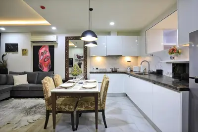 a kitchen and living room with a table and chairs at 2 bdr Apartment Calypso Garden NaiHarn Beach by Capital Pro CGC-310 in Rawai Beach