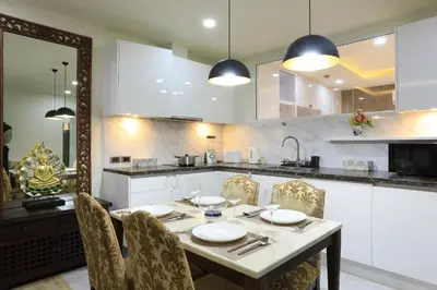 a kitchen with a table with chairs and a sink at 2 bdr Apartment Calypso Garden NaiHarn Beach by Capital Pro CGC-310 in Rawai Beach