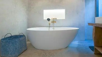 a bathroom with a white tub in a room at Recently renovated 3BR apartment near Layan Beach in Phuket Town
