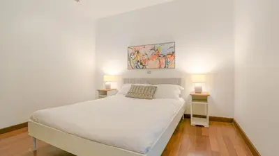 a bedroom with a white bed with two night stands at Recently renovated 3BR apartment near Layan Beach in Phuket Town