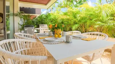 a white dining table with white chairs and a white table at Recently renovated 3BR apartment near Layan Beach in Phuket Town