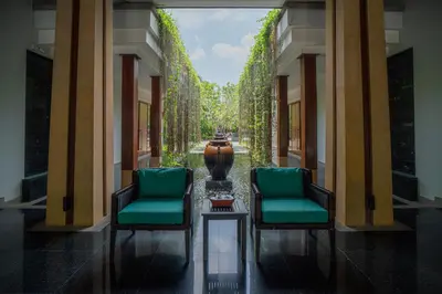 a hallway with two chairs and a vase in the middle at Modern Beachfront Apartment Naithon Beach in Nai Thon Beach
