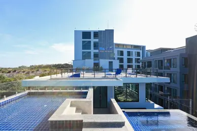 a view of a building with a swimming pool at 1bdr Apartment near NaiHarn beach by Capital Pro in Phuket Town