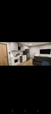 a living room with a couch and a kitchen at Rawai The Title V 1BR in Rawai Beach