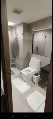 a bathroom with a toilet and a shower at Rawai The Title V 1BR in Rawai Beach