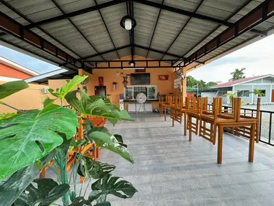 a group of tables and chairs on a patio at พัชรี รีสอร์ท ภูเก็ต Patcharee Resort Phuket in Phuket Town