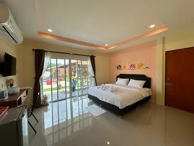 a bedroom with a bed and a sliding glass door at พัชรี รีสอร์ท ภูเก็ต Patcharee Resort Phuket in Phuket Town