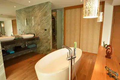 a bathroom with a large tub and two sinks at VILLA Pak Dang in Phuket Town