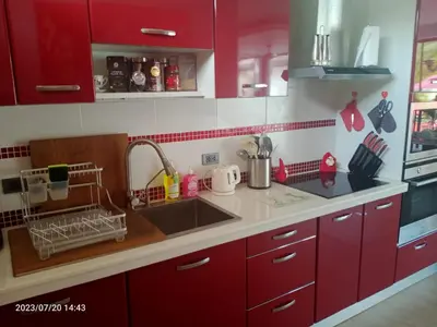 a kitchen with red cabinets and a sink at VILLA Pak Dang in Phuket Town