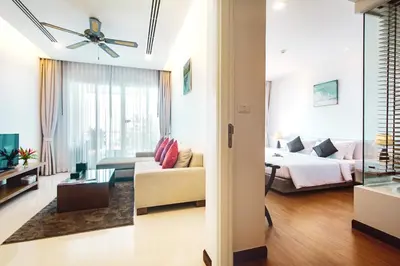 a living room with a bed and a couch at Krabi One Bedroom Seaview in Klong Muang Beach