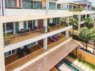 an aerial view of a building with people sitting on a balcony at Krabi One Bedroom Seaview in Klong Muang Beach