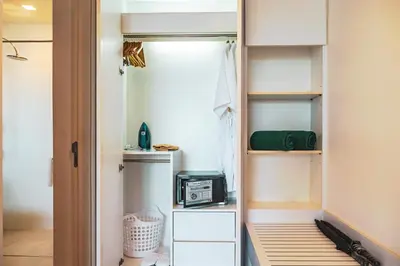 a closet with a door open with a appliance in it at Krabi One Bedroom Seaview in Klong Muang Beach