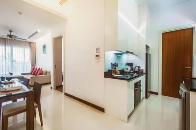 a kitchen and a living room with a table at Krabi One Bedroom Seaview in Klong Muang Beach