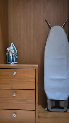 a bed sitting next to a dresser with a pillow at VK House Rawai, Phuket in Rawai Beach