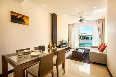 a living room with a dining table and a couch at Krabi Luxury Penthouse in Klong Muang Beach