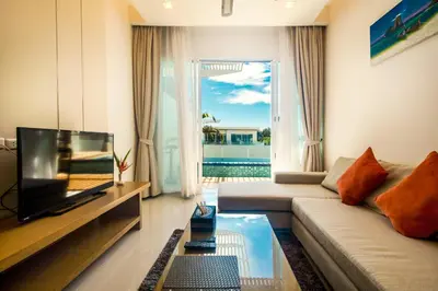 a living room with a couch and a television at Krabi Luxury Penthouse in Klong Muang Beach