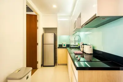 a kitchen with a refrigerator and a counter top at Krabi Luxury Penthouse in Klong Muang Beach